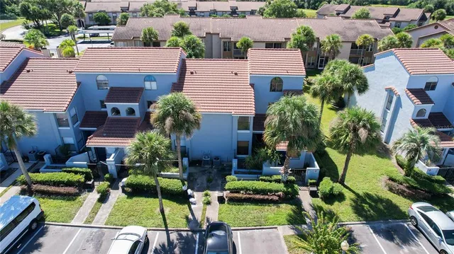 an aerial view of a house with a yard