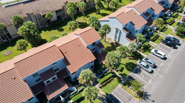 an aerial view of a house with garden space and street view
