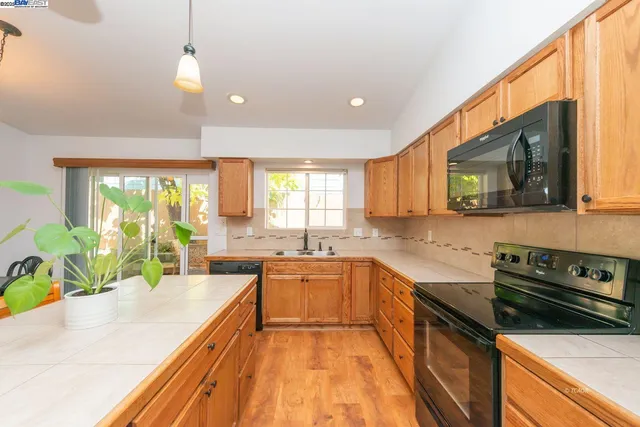a large kitchen with a large window and cabinets