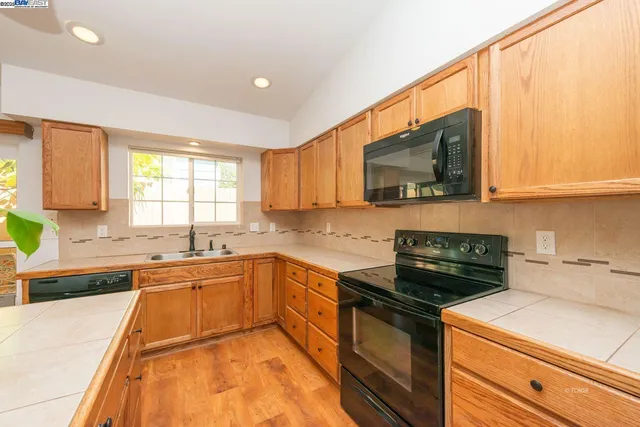 a kitchen with a sink stove and microwave