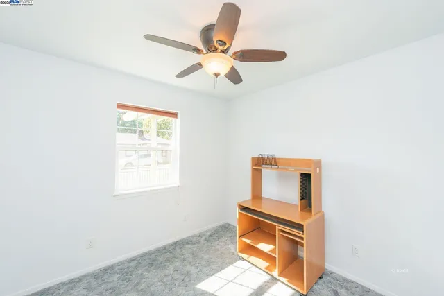 a view of a house next to a yard and large trees