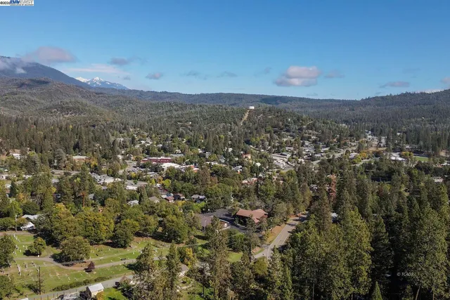a roof deck with table and chairs and potted plants