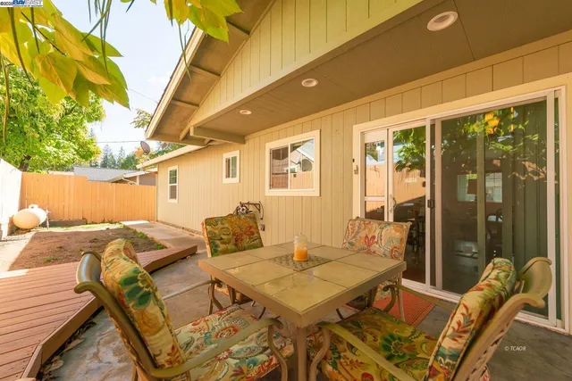 a view of a patio with table and chairs and potted plants