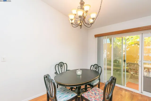 a dining room with furniture a chandelier and a rug