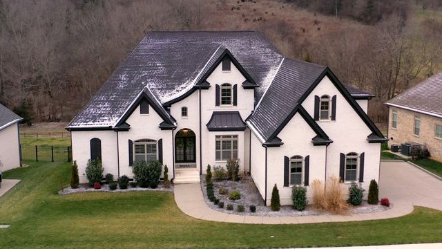 a front view of a house with a yard