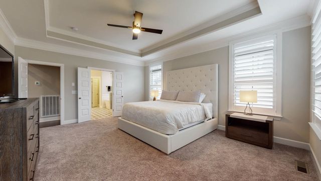 a bedroom with a bed and a lamp