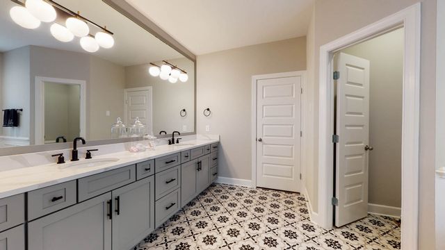 a living room with furniture a flat screen tv and a window