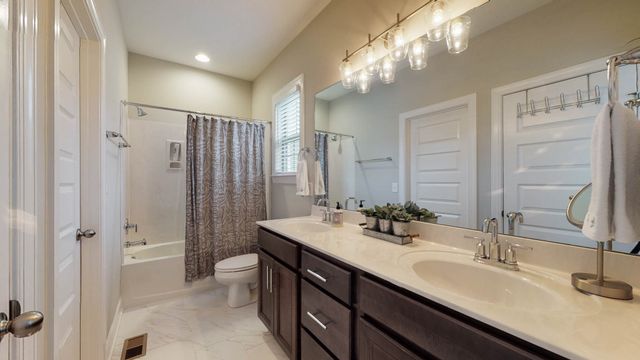 a living room with furniture a flat screen tv and a floor to ceiling window