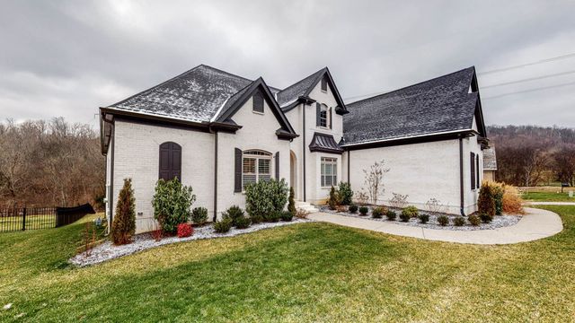 a view of hall way with furniture and a window