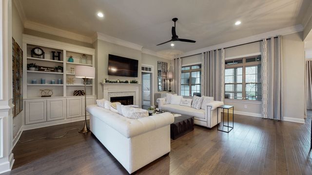 a living room with furniture fireplace and flat screen tv