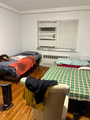 a bedroom with furniture and a window