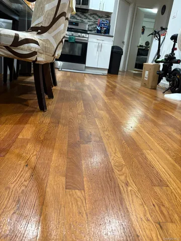 a view of a room with wooden floor and furniture