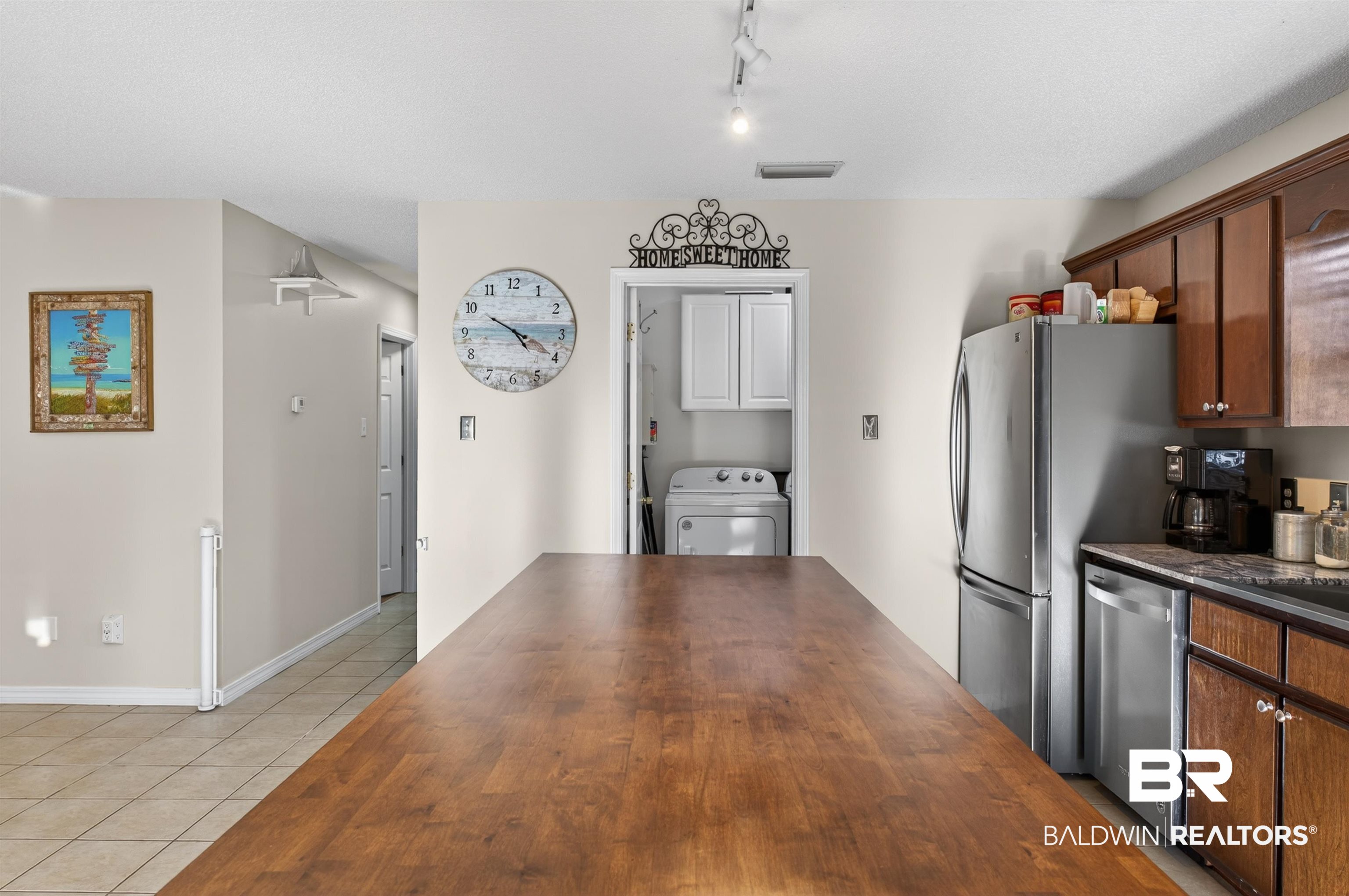 9624 North Bay Street Foley, AL 36535 - Photo 14 of 59 Expansive wood-finish island countertop complementing the kitchen's dark wood cabinetry