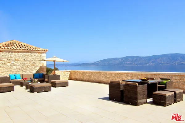 a balcony with furniture and a garden