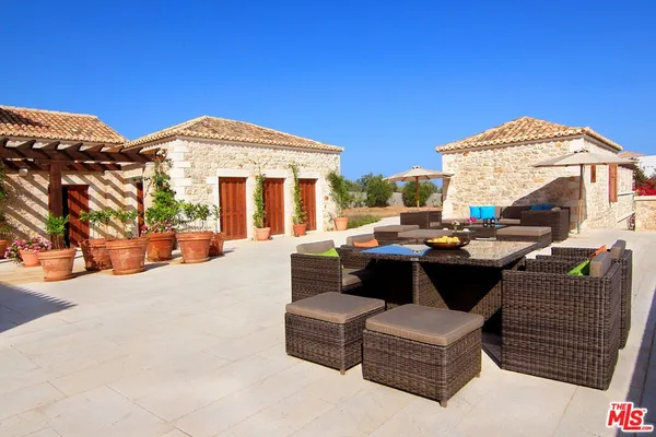 a view of a roof deck with couches and potted plants