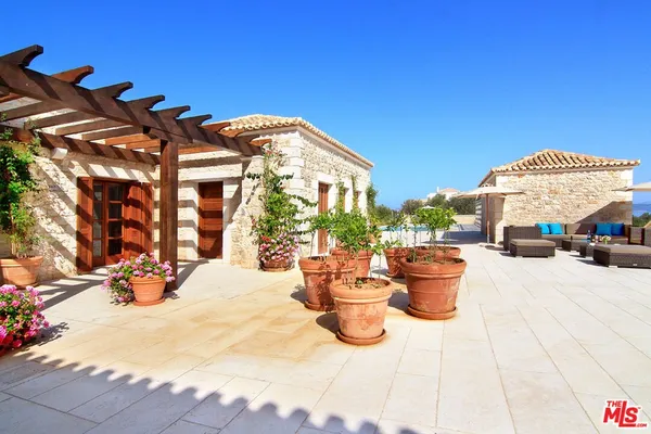 a outdoor living space with furniture and a umbrella