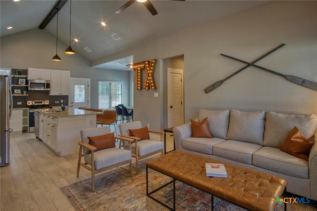 1112 Greenhill Drive Canyon Lake, TX 78133 - Photo 4 of 19 a living room with furniture and kitchen view