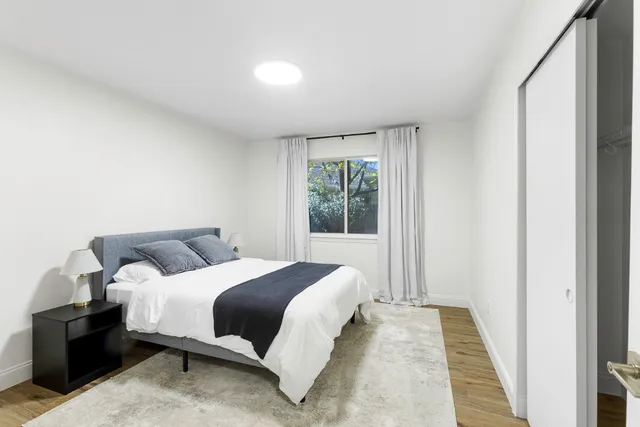 a bedroom with a bed and a window