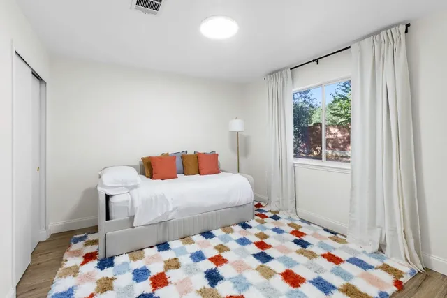 a bedroom with a bed and a window