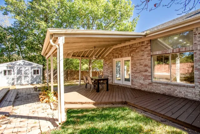 a view of a backyard with table and chairs and potted plants