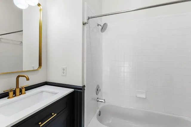 a kitchen with a sink cabinets and wooden floor