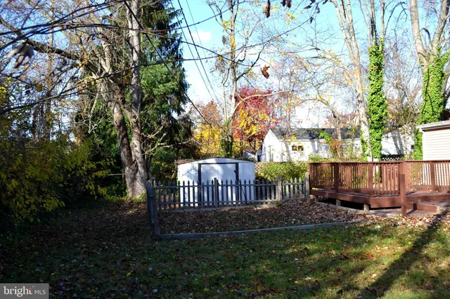 a view of backyard with deck and garden
