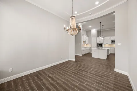 a view of a kitchen with a sink dishwasher a refrigerator and wooden floor
