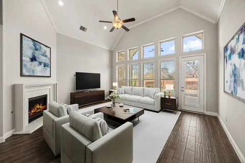 a living room with furniture fireplace and a flat screen tv