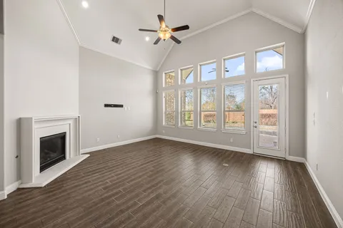 wooden floor fireplace and natural light in room