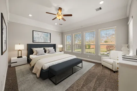 a spacious bedroom with a large bed couch and a large window