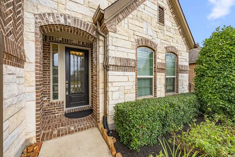 a view of a brick house with potted plants