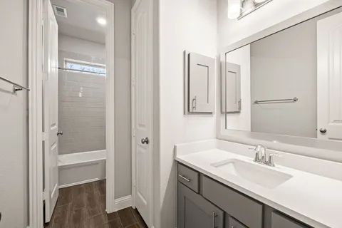 a bathroom with a granite countertop sink mirror and a