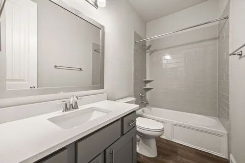 a bathroom with a sink toilet a vanity and shower