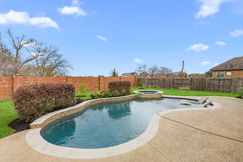 a view of a swimming pool with a yard