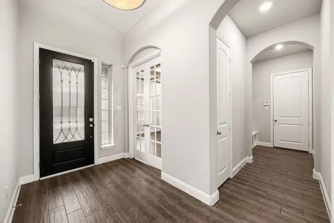 a view of hallway with wooden floor