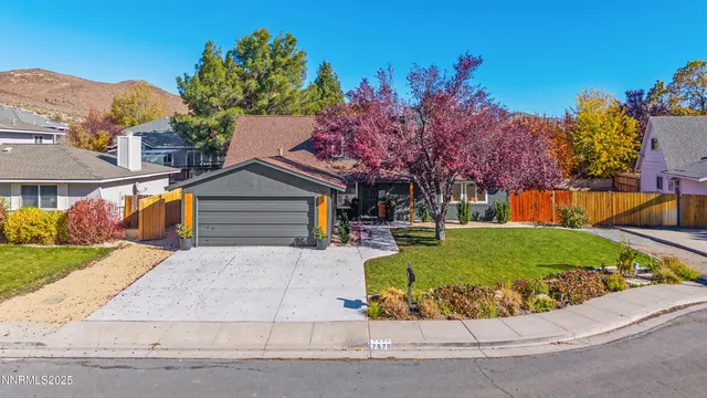 a view of a house with a yard and a garage