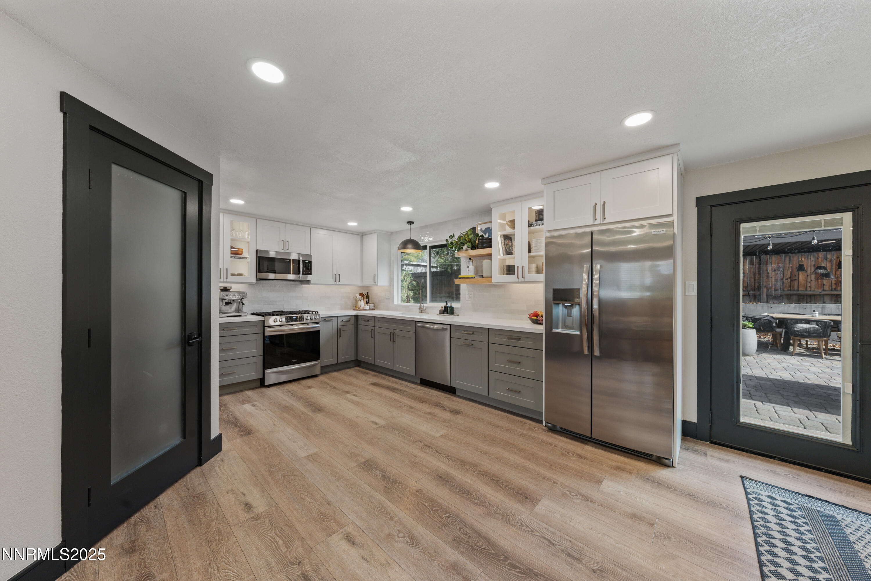 7520 Berryhill Drive Reno, NV 89511 - Photo 11 of 72 a kitchen with stainless steel appliances kitchen island granite countertop a refrigerator a sink a stove and oven
