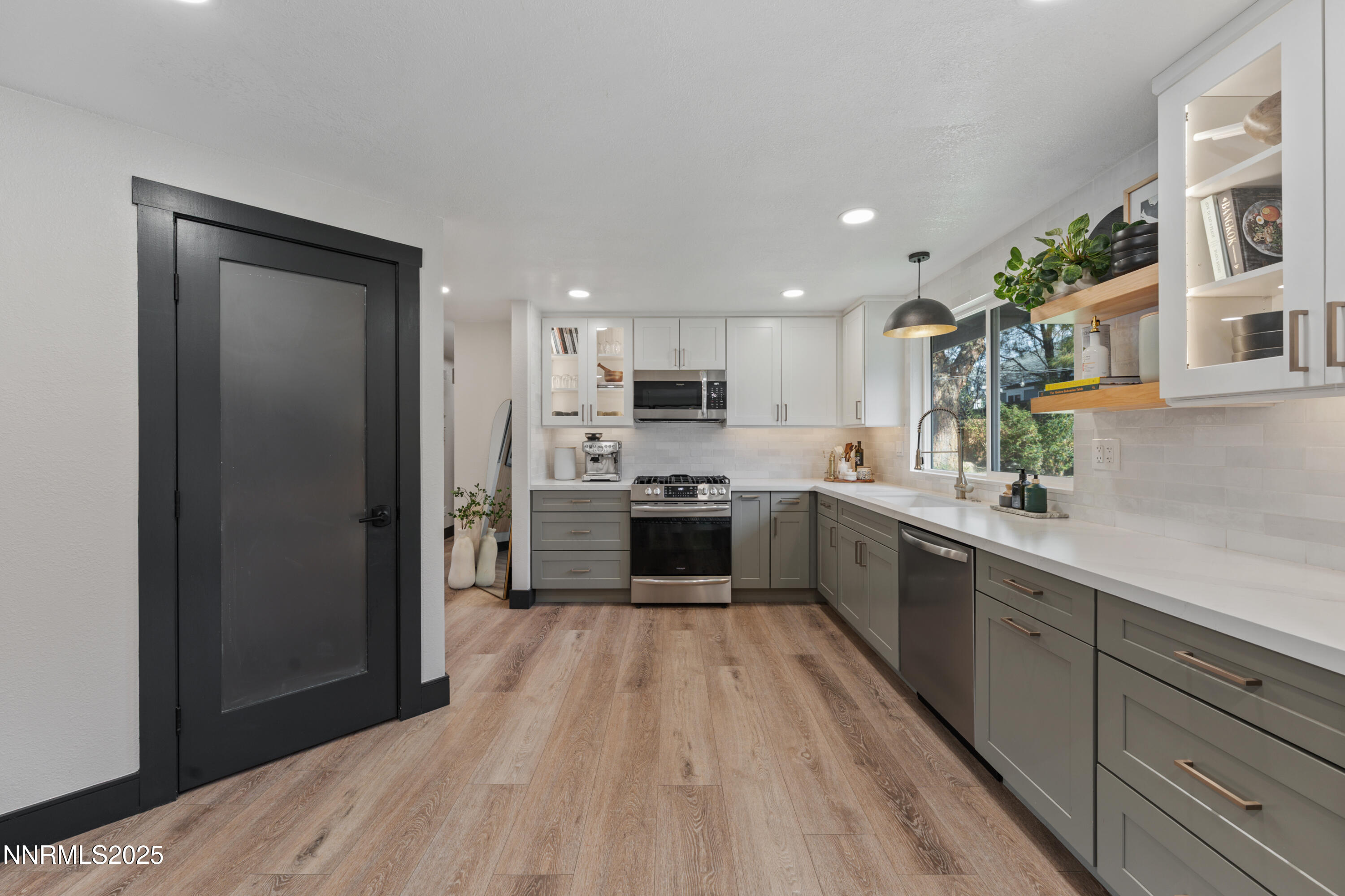 7520 Berryhill Drive Reno, NV 89511 - Photo 12 of 72 a kitchen with a refrigerator a sink and cabinets