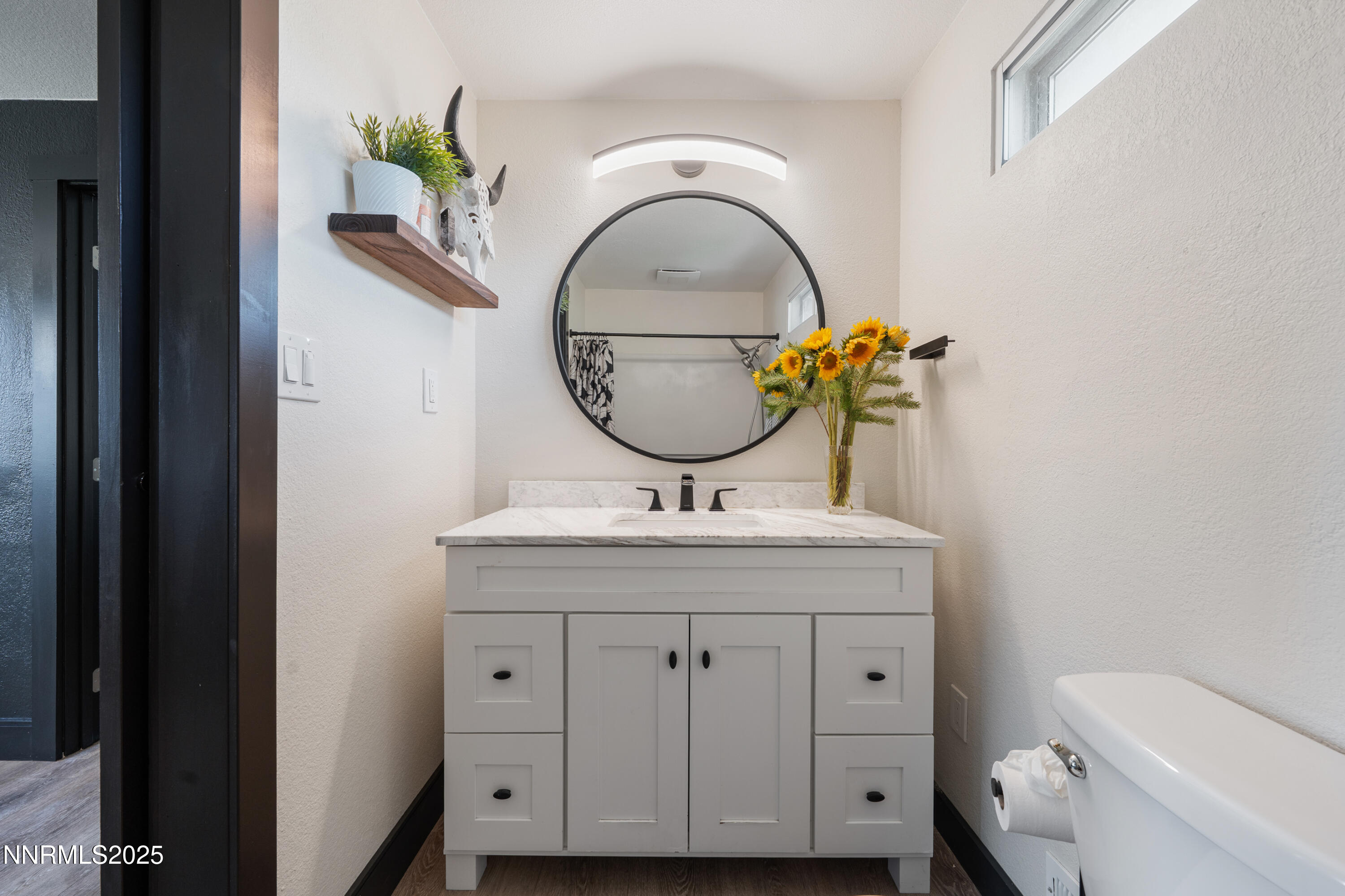 7520 Berryhill Drive Reno, NV 89511 - Photo 50 of 72 a bathroom with a granite countertop toilet a sink and mirror