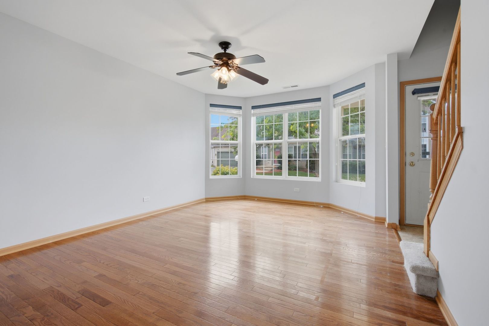 1758 Edith Lane Aurora, IL 60504 - Photo 5 of 28 a view of an empty room with wooden floor and a window