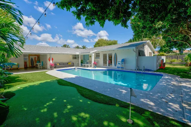 a view of house with a swimming pool