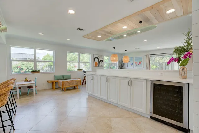 a kitchen with stainless steel appliances kitchen island granite countertop a stove and white cabinets