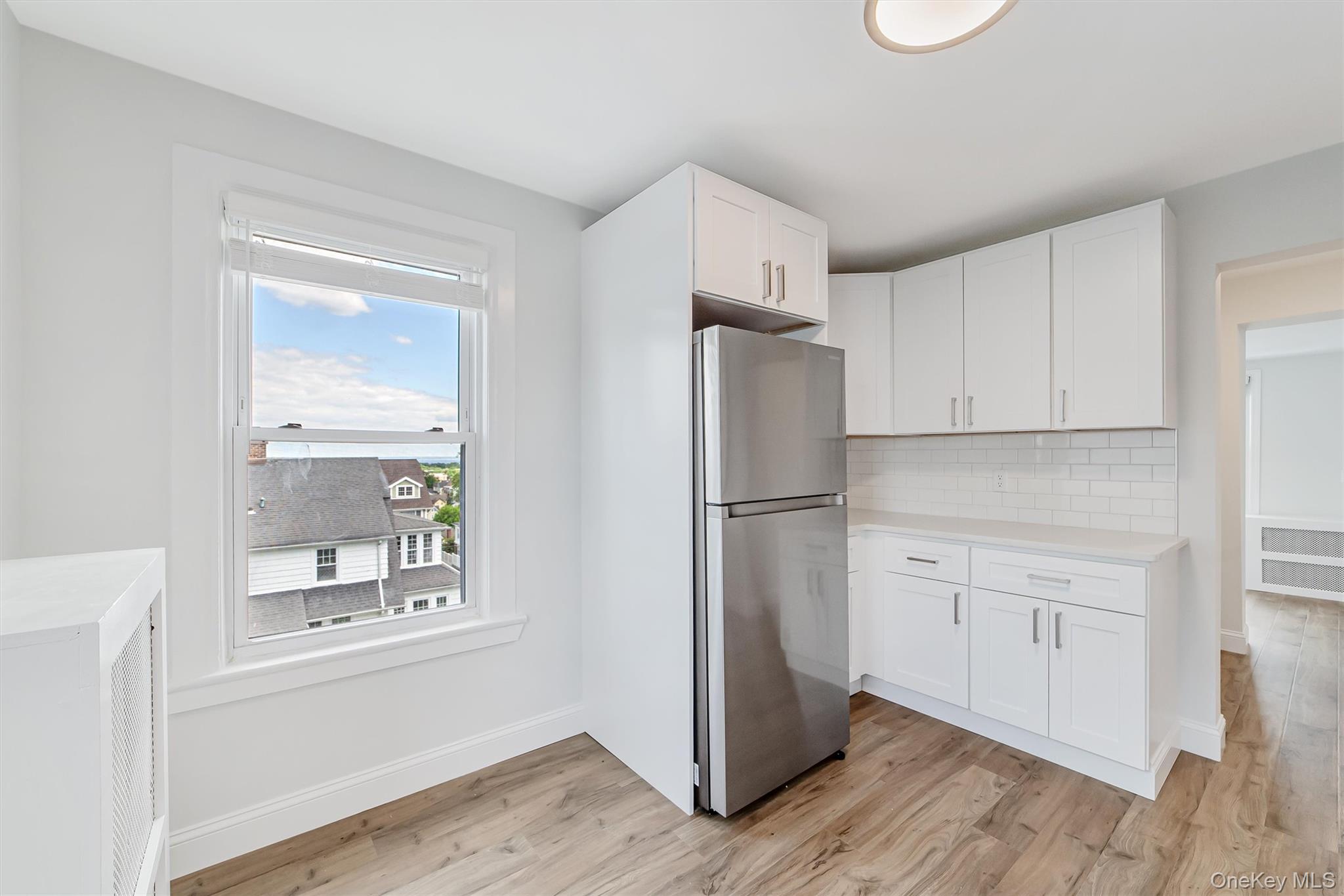 69 Prospect Street, Unit 2 Port Chester, NY 10573 - Photo 14 of 29 a kitchen with a refrigerator a stove and white cabinets