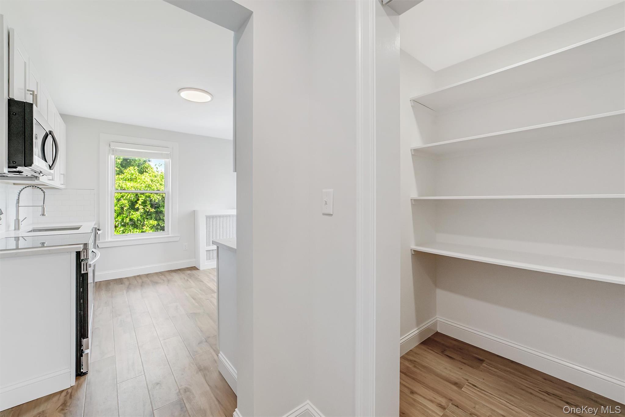 69 Prospect Street, Unit 2 Port Chester, NY 10573 - Photo 16 of 29 a view of room with window and wooden floor