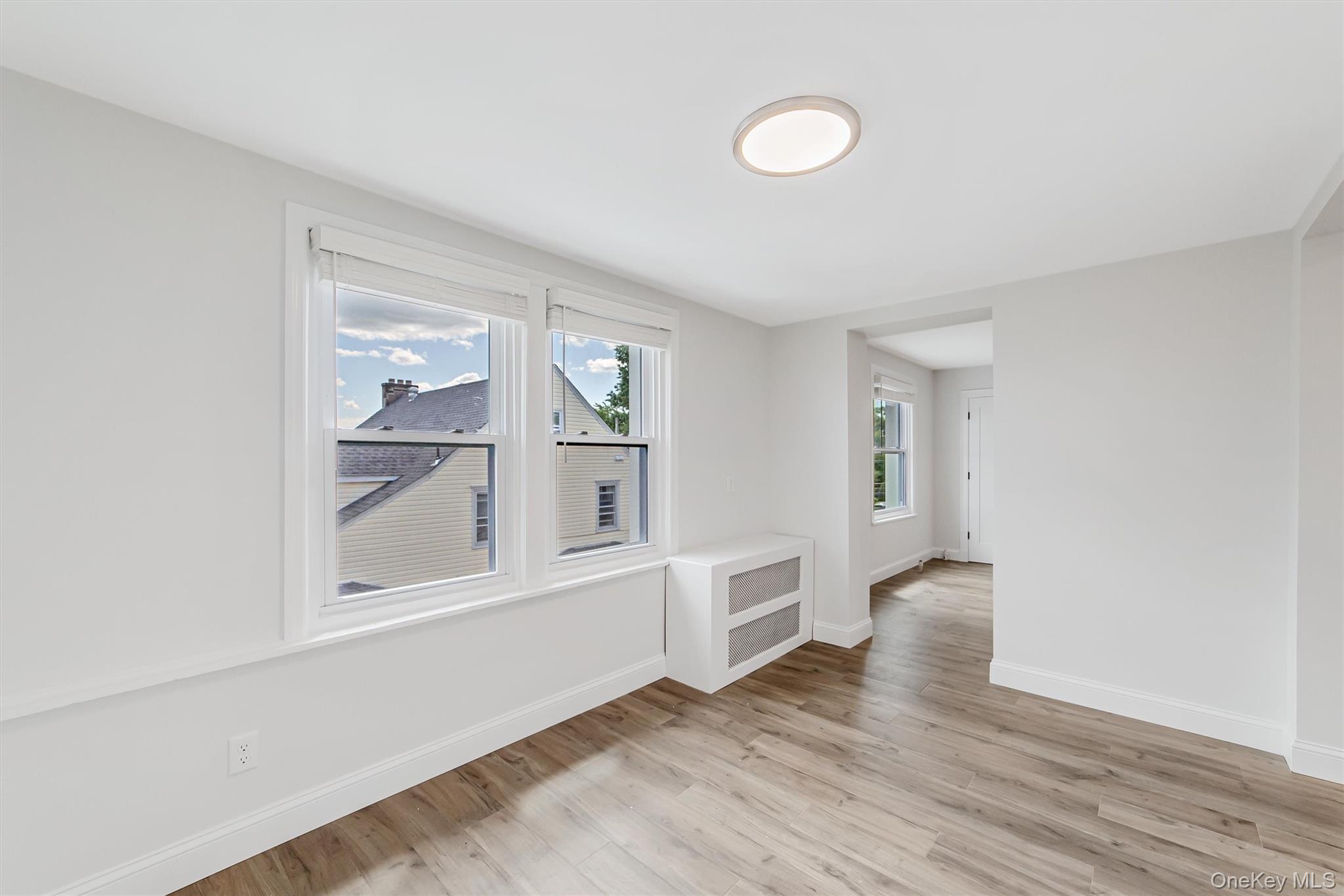 69 Prospect Street, Unit 2 Port Chester, NY 10573 - Photo 18 of 29 an empty room with wooden floor and windows