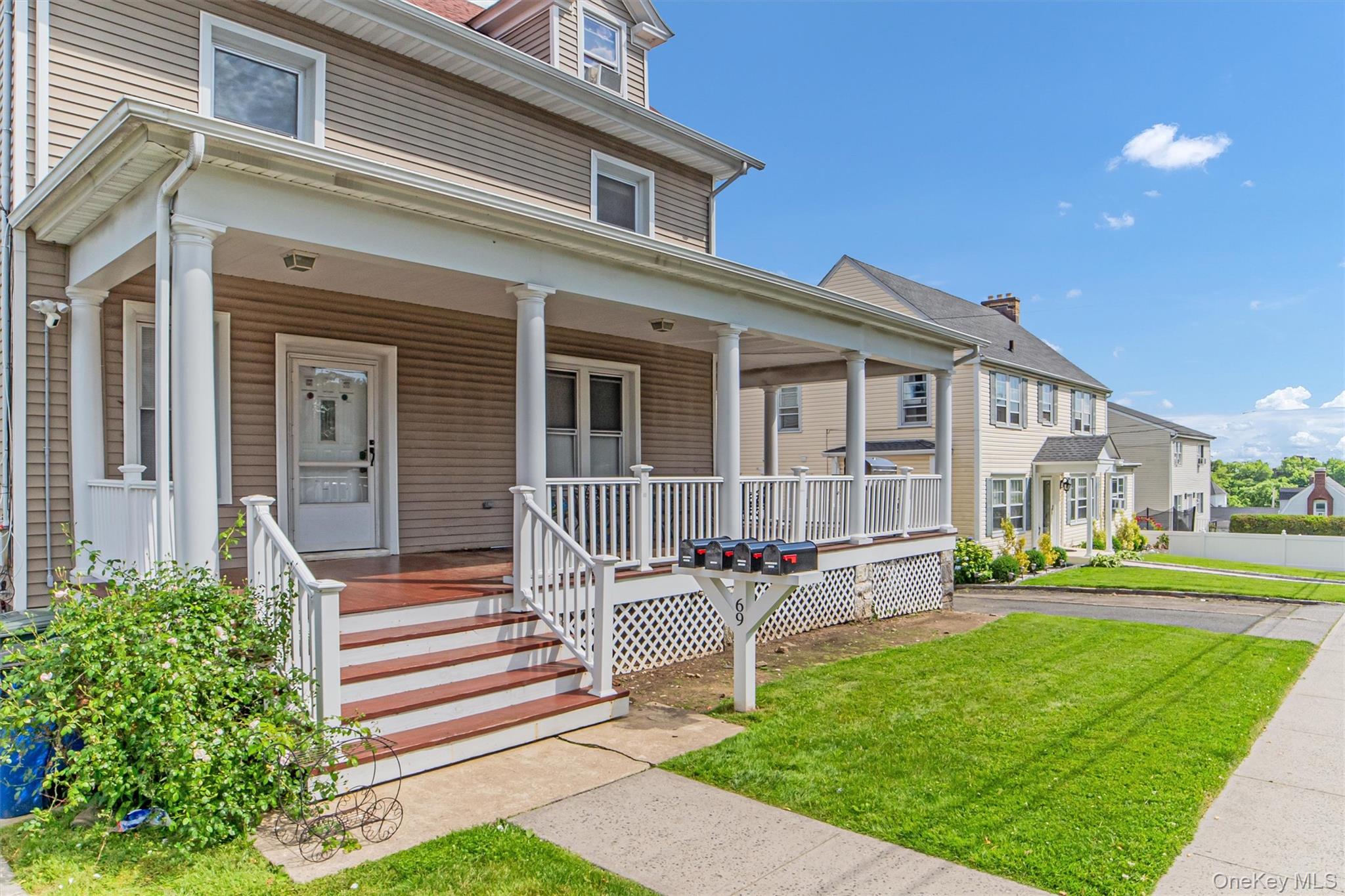 69 Prospect Street, Unit 2 Port Chester, NY 10573 - Photo 2 of 29 a front view of a house with a yard table and chairs