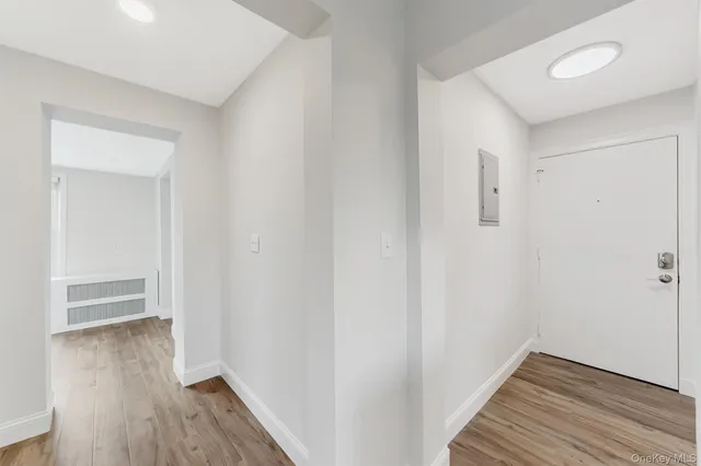 a view of hallway with wooden floor
