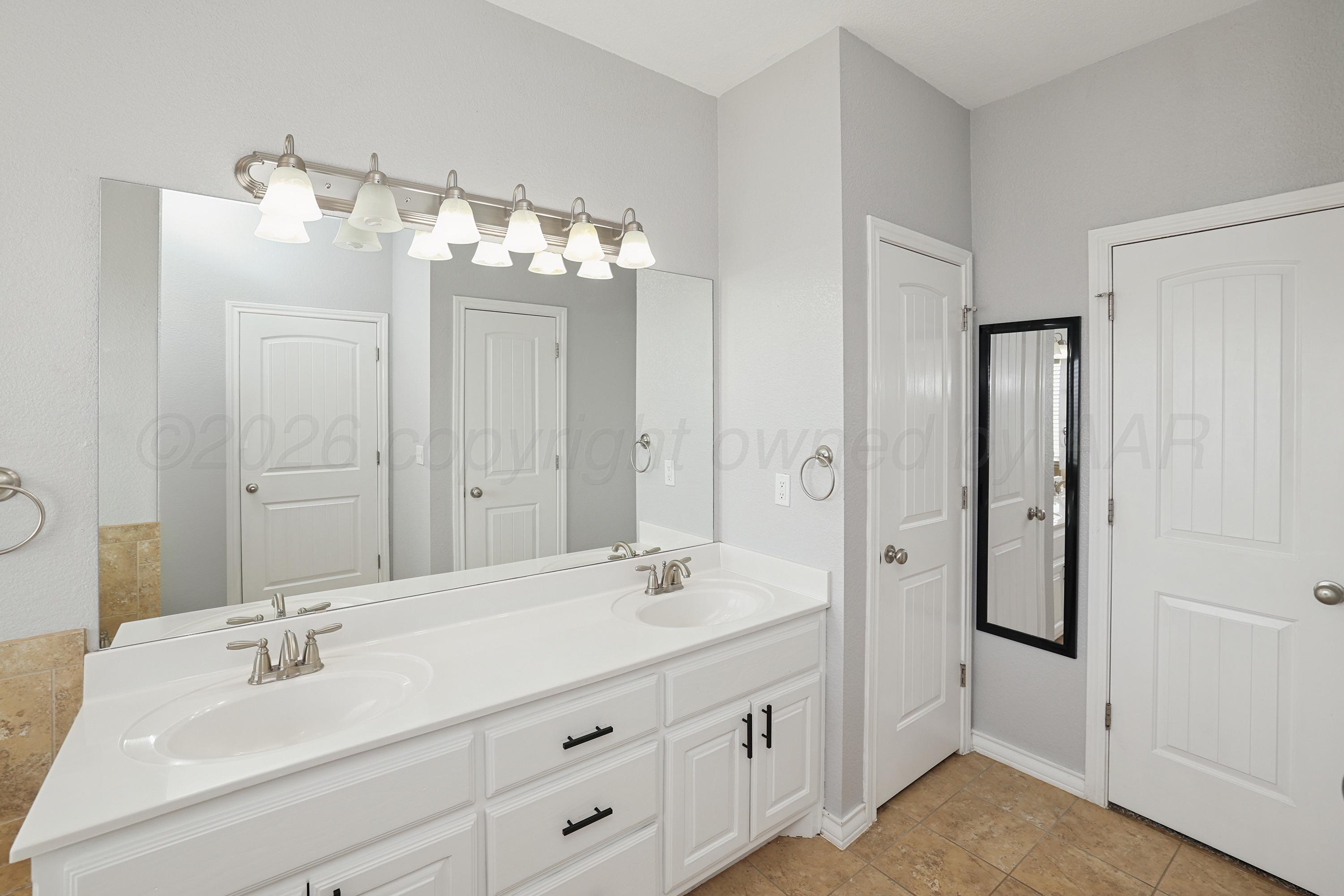 19101 Sundancer Lane Bushland, TX 79124 - Photo 11 of 25 a bathroom with a double vanity sink and mirror
