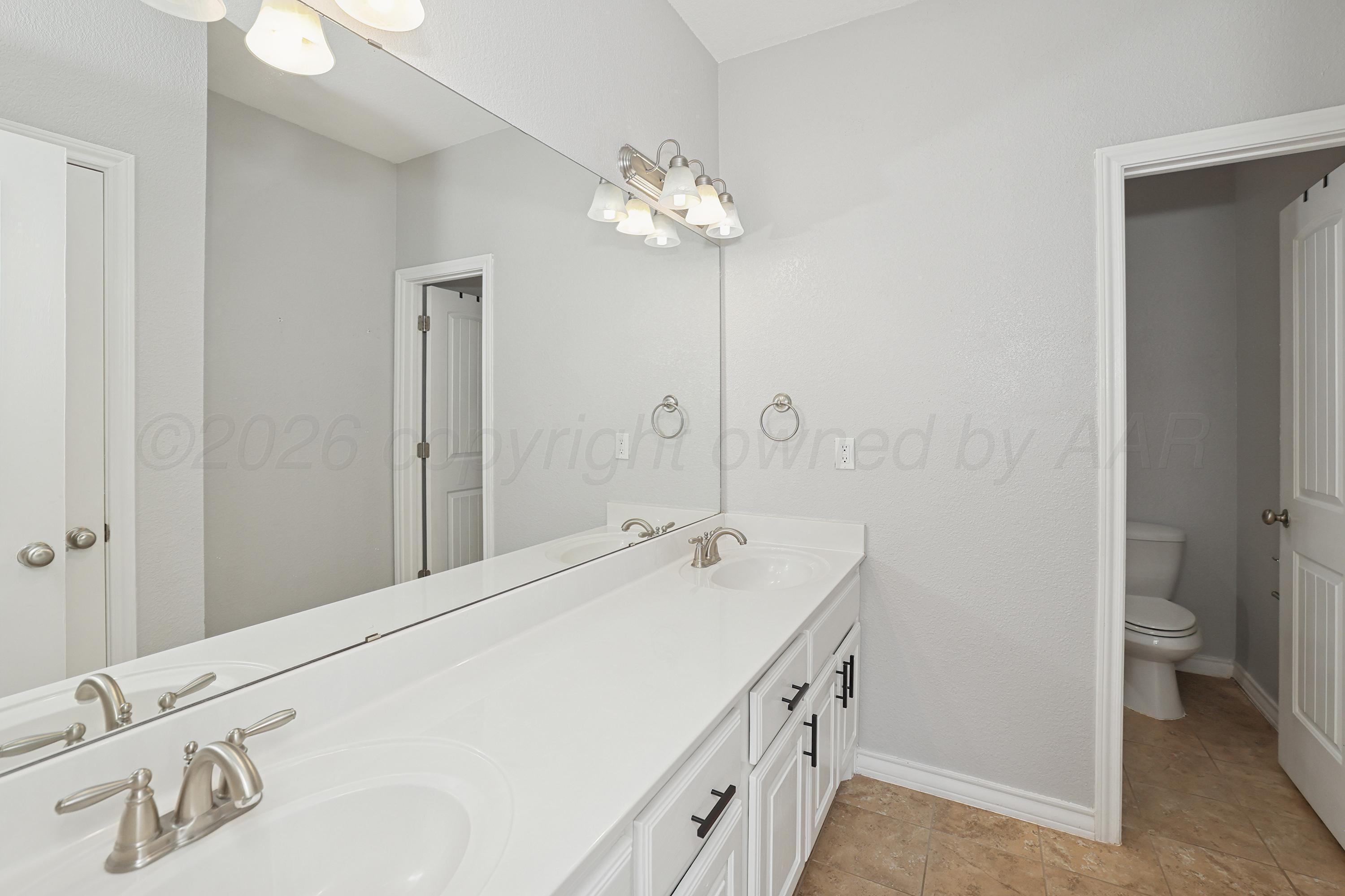 19101 Sundancer Lane Bushland, TX 79124 - Photo 20 of 25 a spacious bathroom with a double vanity sink and a mirror