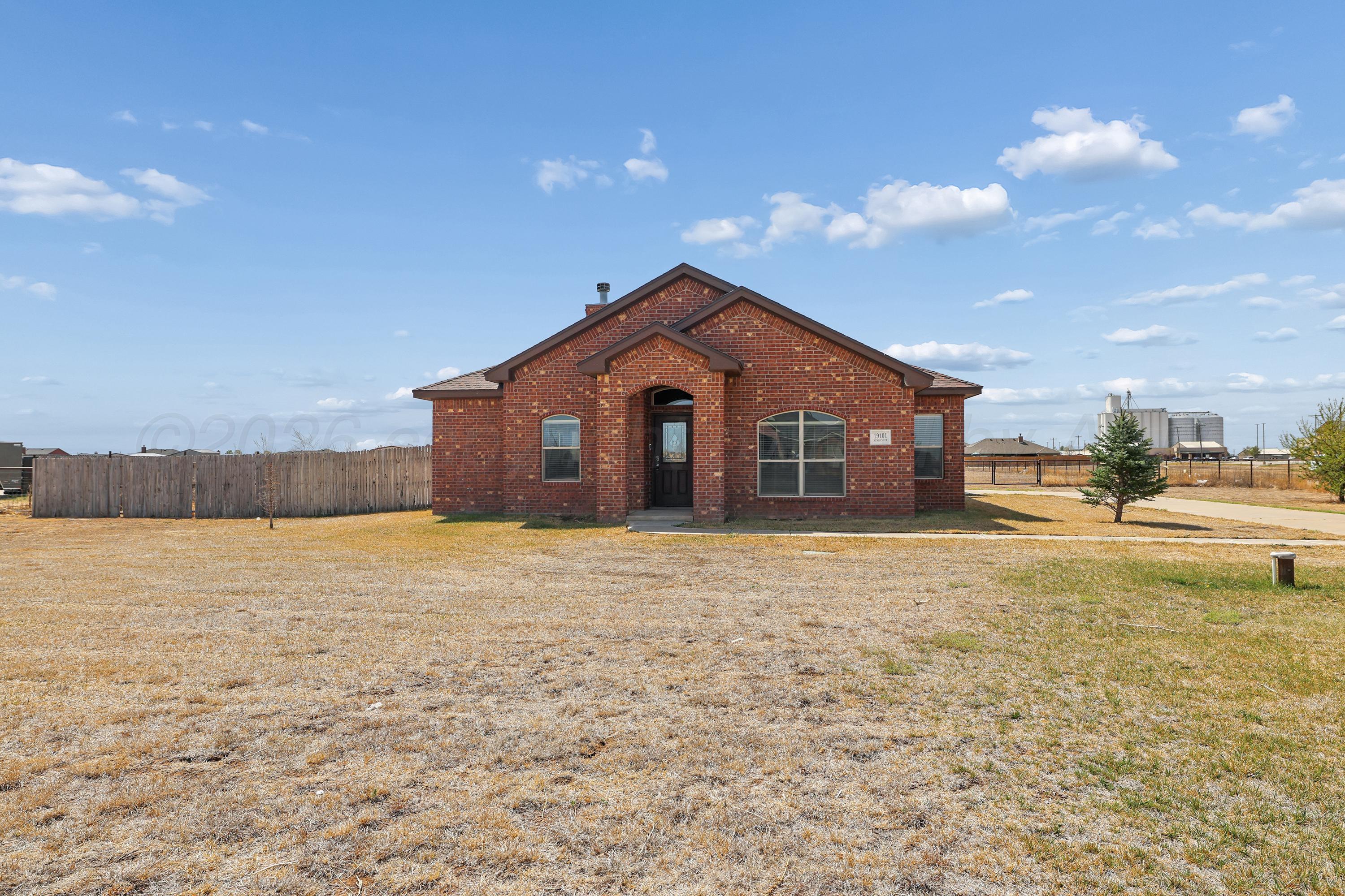 19101 Sundancer Lane Bushland, TX 79124 - Photo 2 of 25 a view of a house with a yard and garage